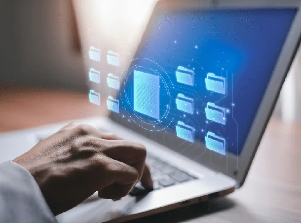 Man typing in computer with blue background and folders coming out.